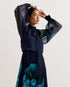 MANAMI-Dresses-The MANAMI maxi dress exudes glamour from head to toe, starting with a classic bow tie around the neck and ending with a fine pleated skirt. Floral details are printed on this piece to add an understated splash of colour, finished out with sheer bishop sleeves and a full hem to create plenty of swish. Maxi dress Large scale floral print details High neck with pussybow tie Sheer long bishop sleeves Pleated A-line skirt Front split Concealed zip fastening Chae is 5'9.5" / 1.77m and wears a Ted